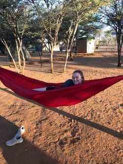 Student laying in a hammock